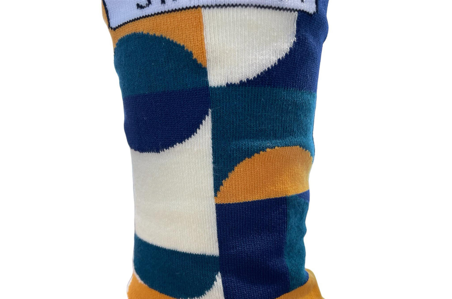 Green Socks with Orange, cream and navy geometric pattern by Stand Out Socks. The Stand Out logo on the top with the Stand Out website on the sole.