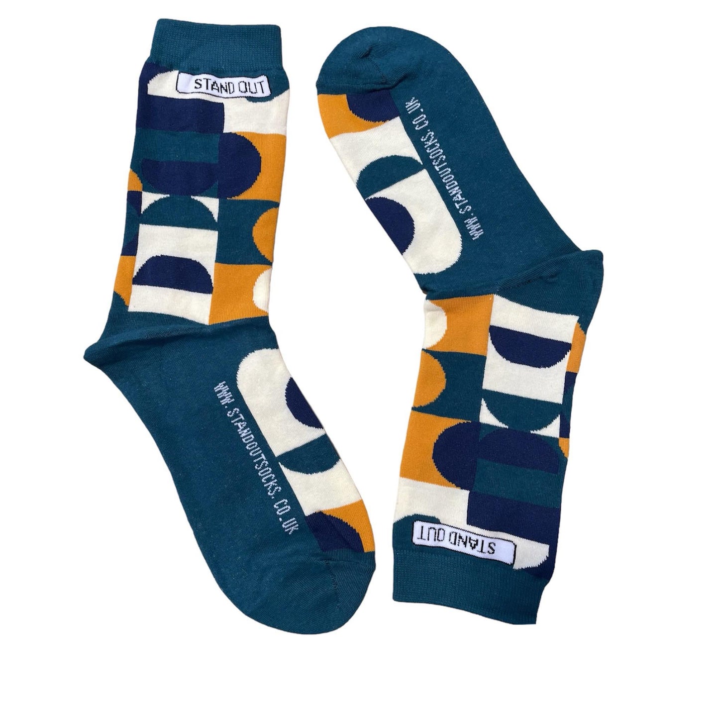 Green Socks with Orange, cream and navy geometric pattern by Stand Out Socks. The Stand Out logo on the top with the Stand Out website on the sole.