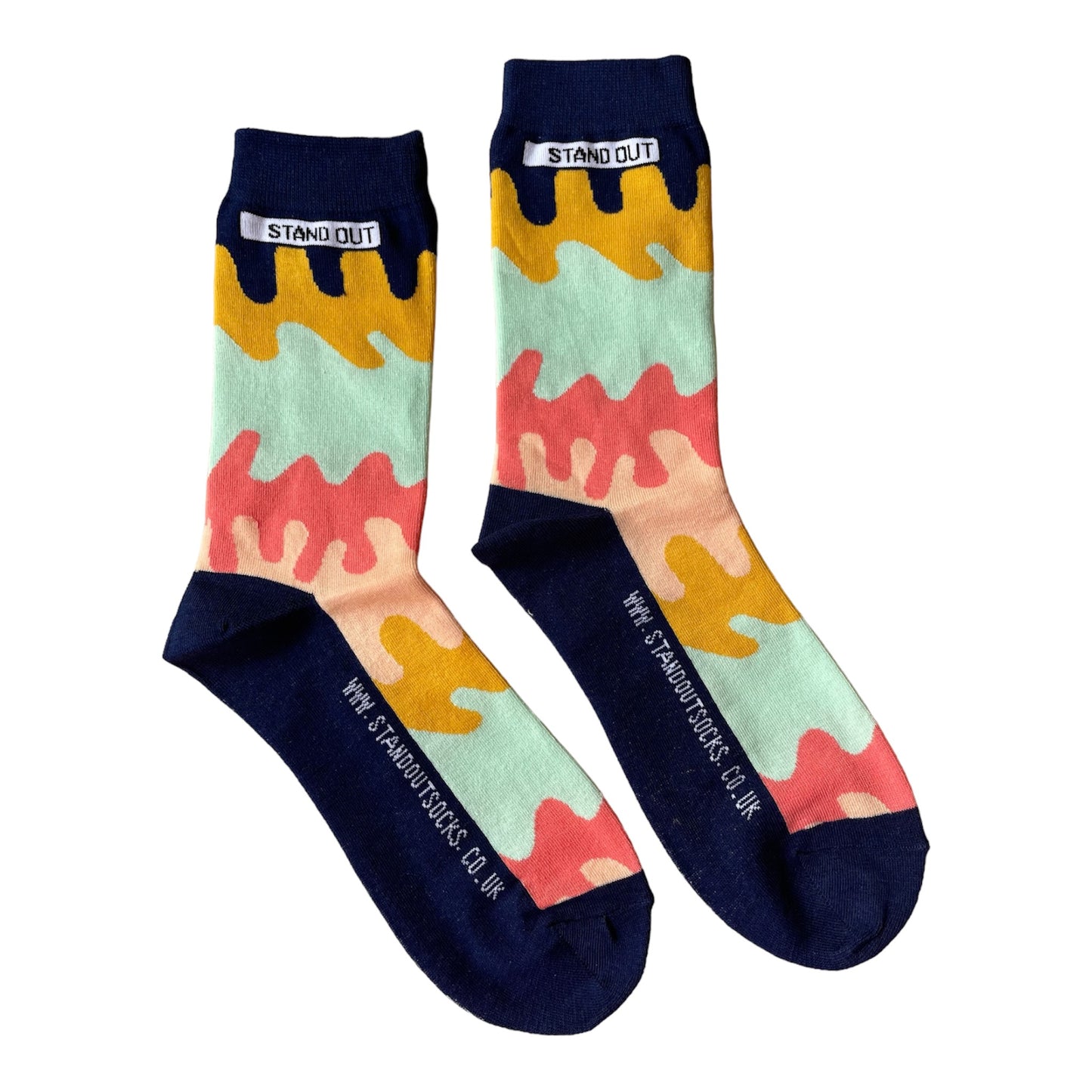 A blend of colours which look like they are dripping pattern  by Stand Out Socks. The Stand Out logo on the top with the Stand Out website on the sole.