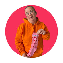 Load image into Gallery viewer, Lady with orange jumper on holding up a pair of pink socks with tomato pattern, surrounded by a pink circle border.
