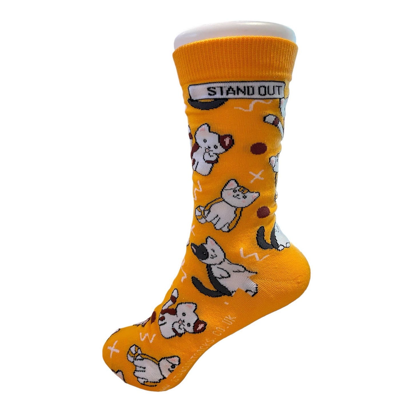 An orange sock with cat pattern and a stand out logo displayed on a foot mannequin 